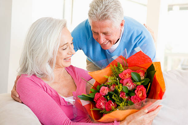 istock Husband giving wife flowers and smiling 92126597