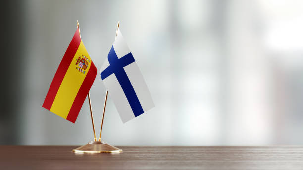 istock Spanish And Finnish Flag Pair On A Desk Over Defocused Background 921266246