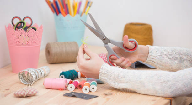 istock girl sews doll clothes 921267036