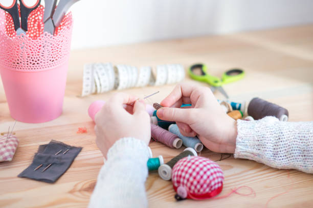 istock girl sews doll clothes 921267348