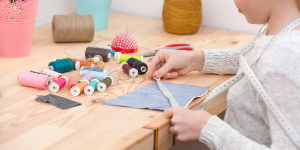 istock girl sews doll clothes 921267654