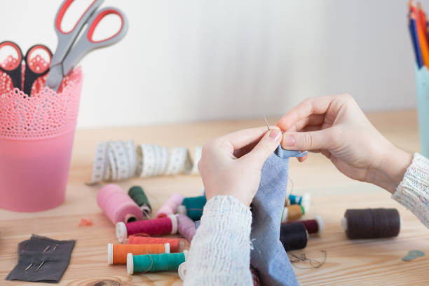 istock girl sews doll clothes 921269872