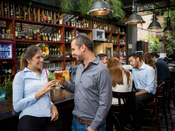 istock Happy couple drinking beers at a bar 921270230