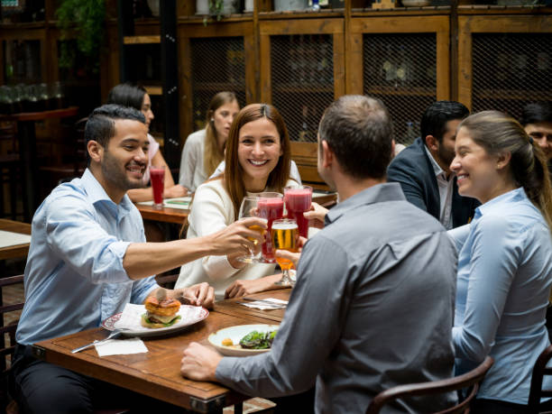 istock Group of friends making a toast at a restaurant 921270264