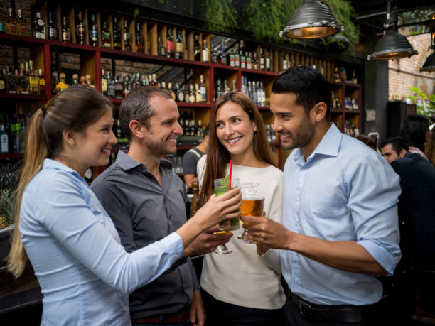 istock Group of friends making a toast at the bar 921270280