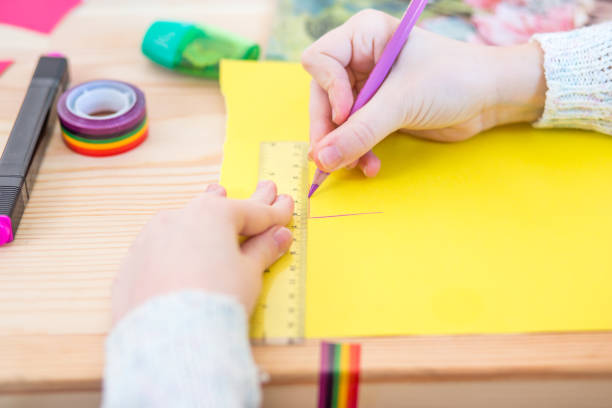 istock Girl play with scissors and color paper 921270620