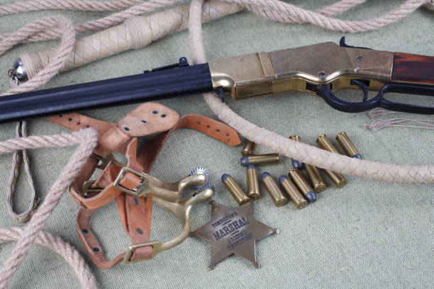 istock Wild west period repeating rifle with ammunition and sheriff badge 921270732
