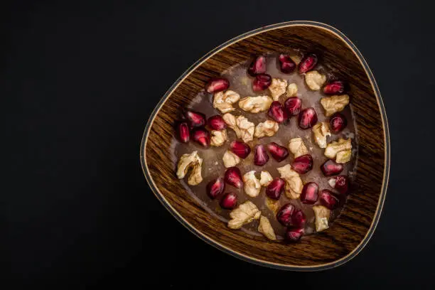 Turkish dessert Ashura, Noah's pudding, with pomegranate seeds and walnuts