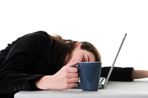 istock Woman holding a coffee mug while sleeping on her desk 92127424