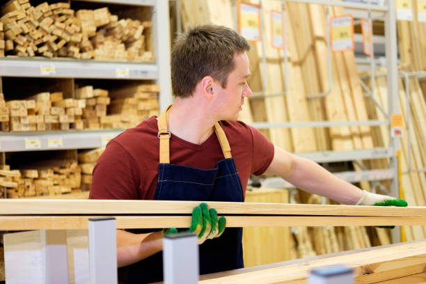 istock worker or seller in construction store or warehouse wood department at work 921276544