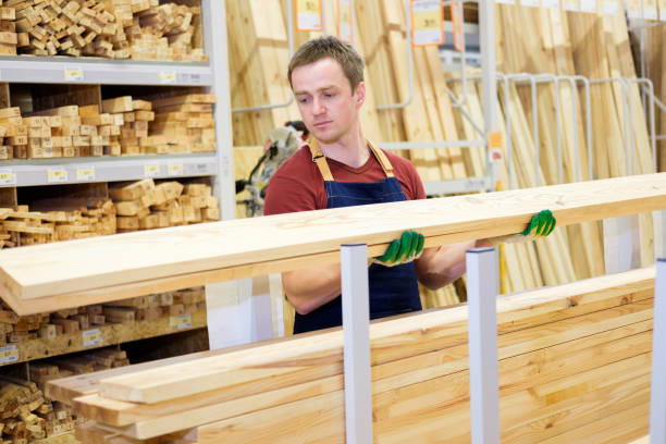 istock worker or seller in construction store or warehouse wood department at work 921276548