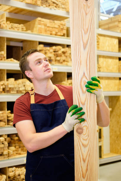 istock worker or seller in construction store or warehouse wood section at work 921276570