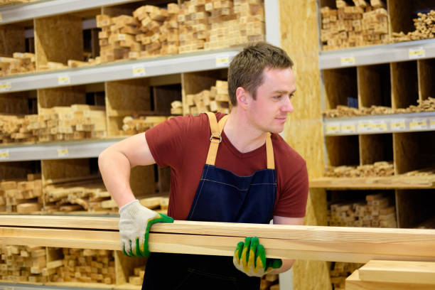 istock worker or seller in construction store or warehouse wood section at work 921276582