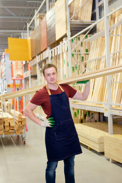 istock worker or seller in construction store or warehouse wood department at work 921276584