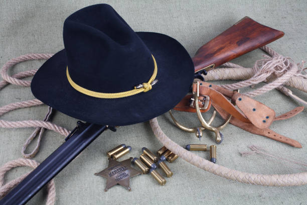istock Wild west period repeating rifle with ammunition and sheriff badge 921276650