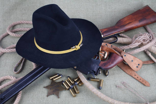 istock Wild west period repeating rifle with ammunition and sheriff badge 921276754