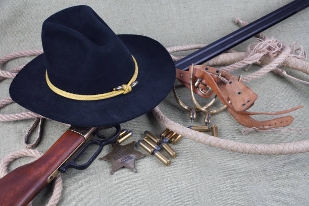 istock Wild west period repeating rifle with ammunition and sheriff badge 921276812