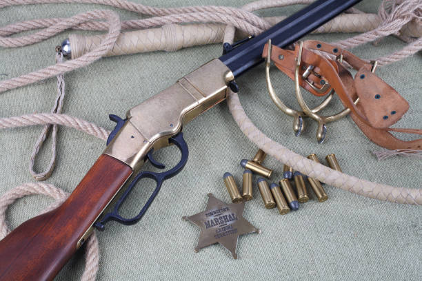 istock Wild west period repeating rifle with ammunition and sheriff badge 921276834