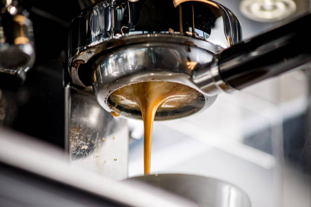 istock Close-up of espresso pouring from coffee machine. Professional coffee brewing 921276896