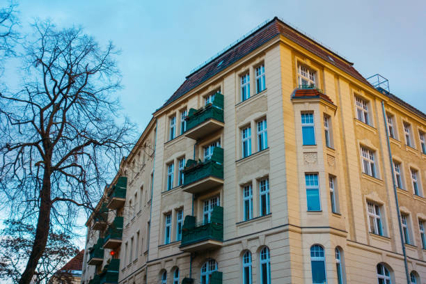istock orange big corner building with green balcony 921277204
