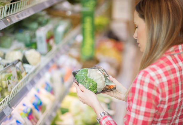 istock Woman buying a packet of vegetables 921279792
