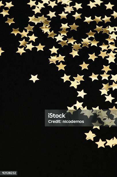 Golden Stars Falling From The Top On Black Background Stock Photo - Download Image Now