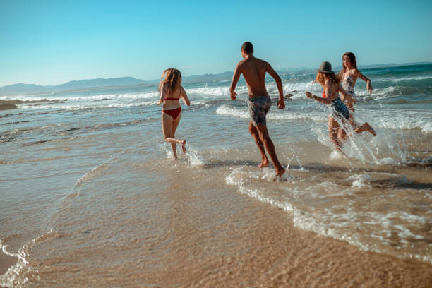 istock Young friends having fun by the sea 921284292