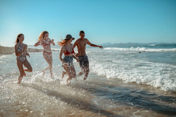 istock Young friends having fun by the sea 921284302