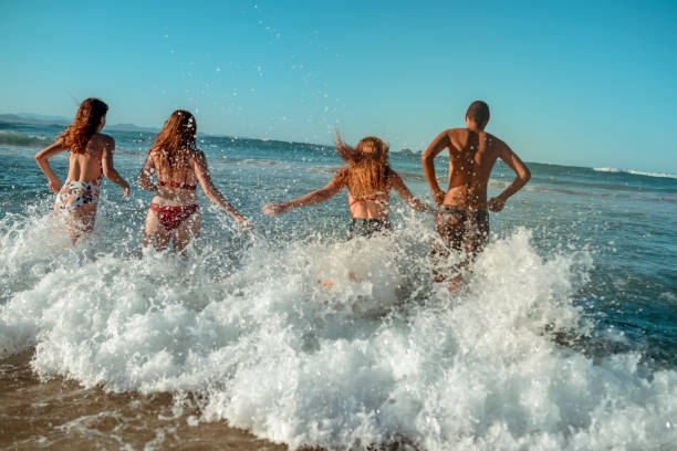 istock Young friends having fun by the sea 921284310