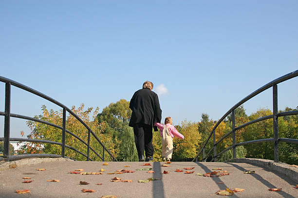 istock behind grandmother and baby on autumn bridge 92128593