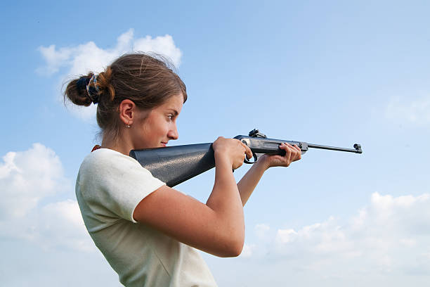 Close-up View of Shot Gun Muzzle Held by Unrecognizable Adult Woman