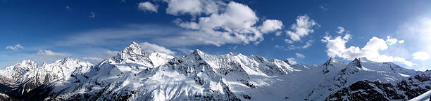 Winter mountain scene. High sharp rocks and snow. Cold weather and frost. View of the mountains. Photo for postcards, backgrounds, wallpapers.