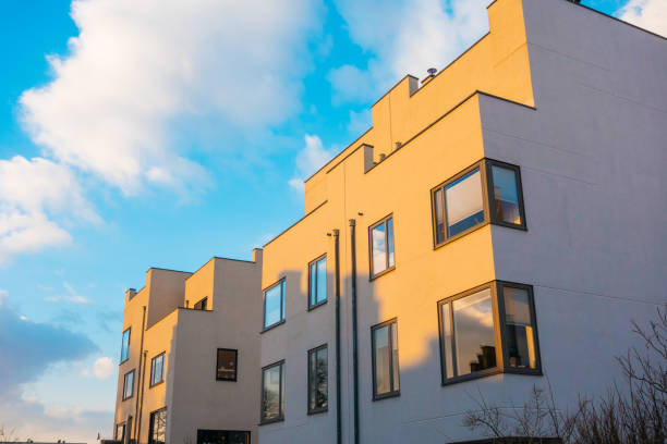 big white apartment building with warm sunlight and some shaped shadows