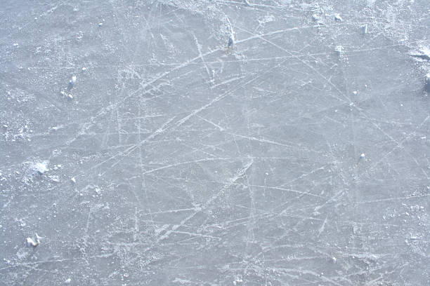 Skate marks and cracks on the surface of an outdoor ice rink Surface of an outdoor ice rink replete with skate marks. figure skating stock pictures, royalty-free photos & images