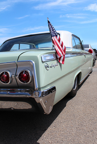 Old style American car and American flag.