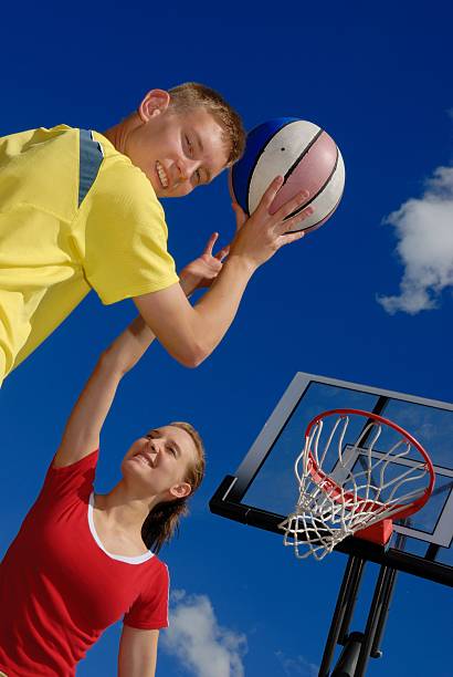 Siblings playing basketball stock photo