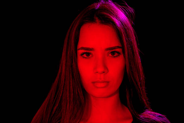 istock Young Lady Studio Headshot Serious with Red and Purple Cast 921296960