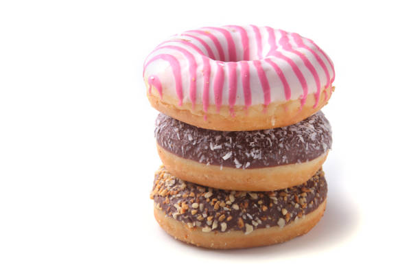 istock Assorted doughnuts in the glaze, colorful sprinkles and nuts on a white background. 921297450
