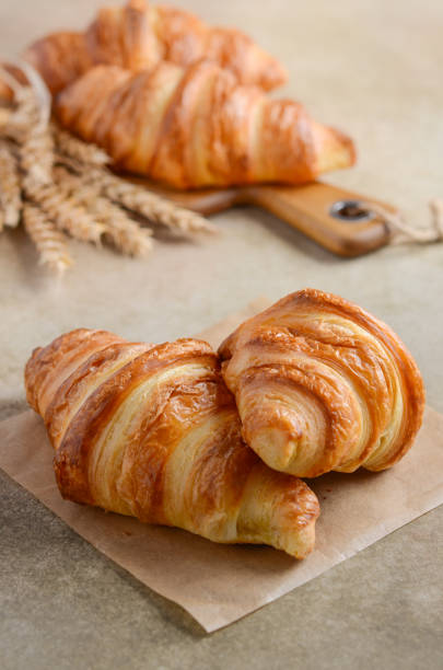 istock Fresh Croissants on brown concrete background 921299620