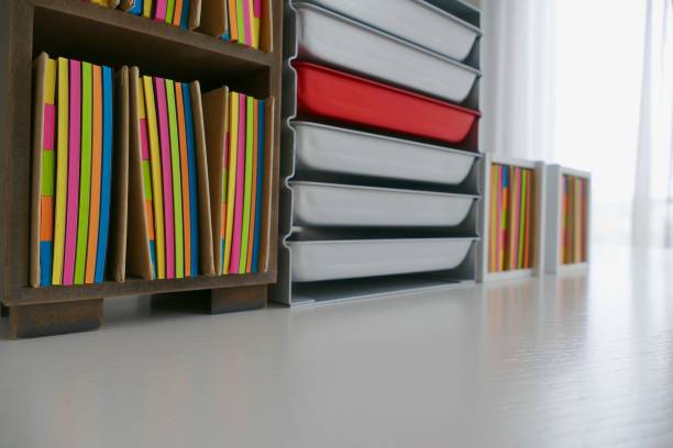 istock Stationery boxes and colorful adhesives notes in a row, on a white table 921299646
