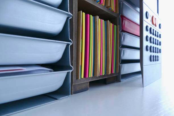 istock Stationery boxes and colorful adhesives notes in a row, on a white table 921302164