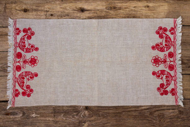 Embroidery linen napkin on the old wooden table stock photo