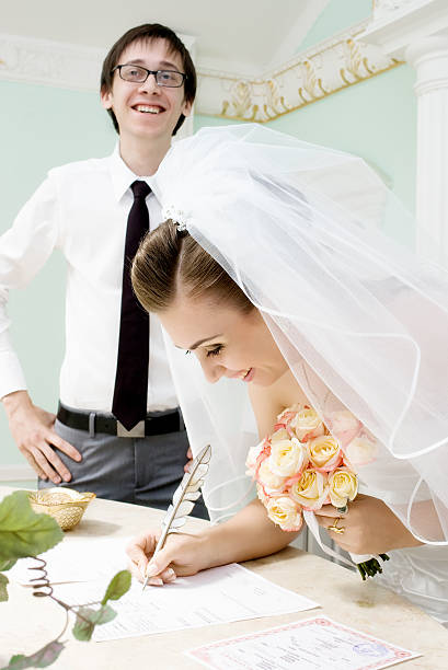 istock smiling bride signs marriage certificate 92130324