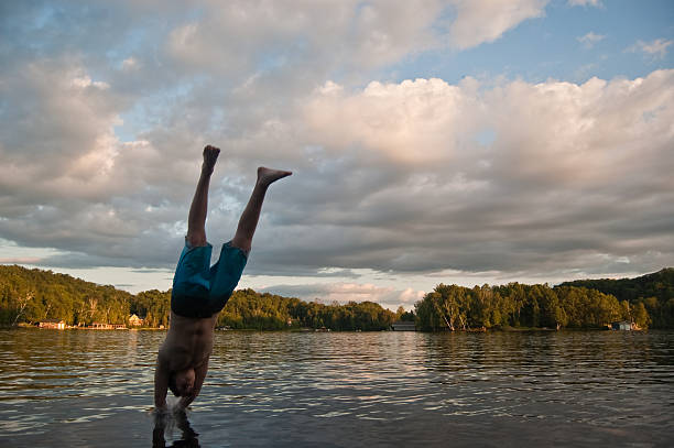 istock Young Man Diving into the Lake at Dusk 92130374