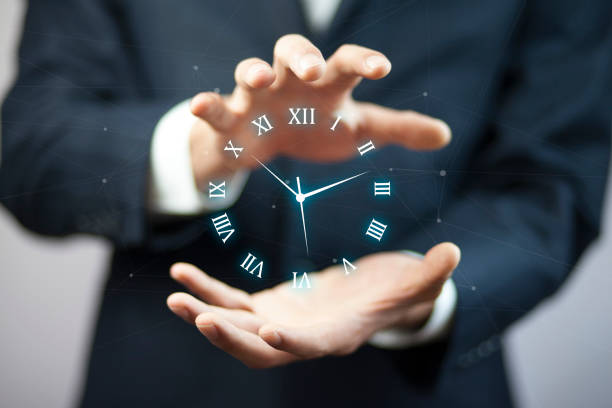 istock Business man hand holding clock in screen 921312344