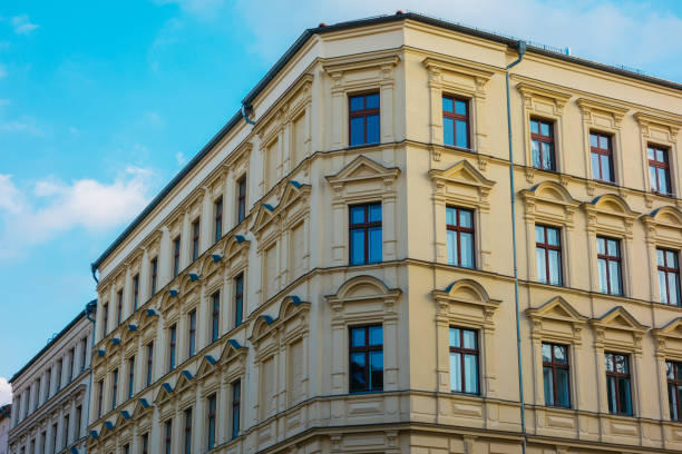 istock residential corner building with yellow facade 921315022