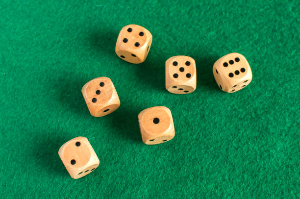 istock Wooden dice set on green felt cloth 921315148