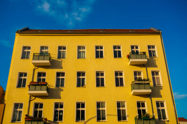 istock yellow colored apartment building in high contrasts 921315576