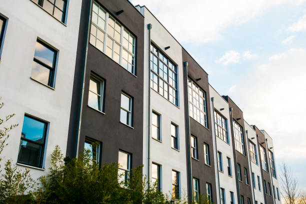 istock white and black townhouses with green bush 921325012