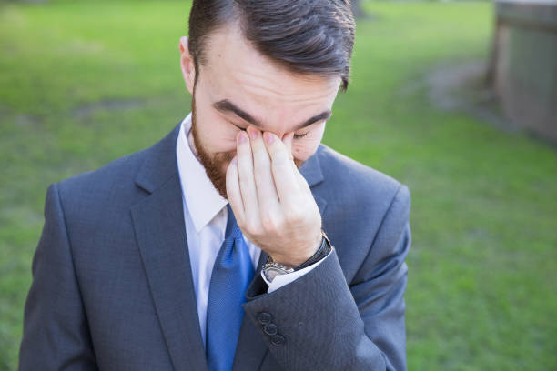 istock Tired young man in suit 921327858